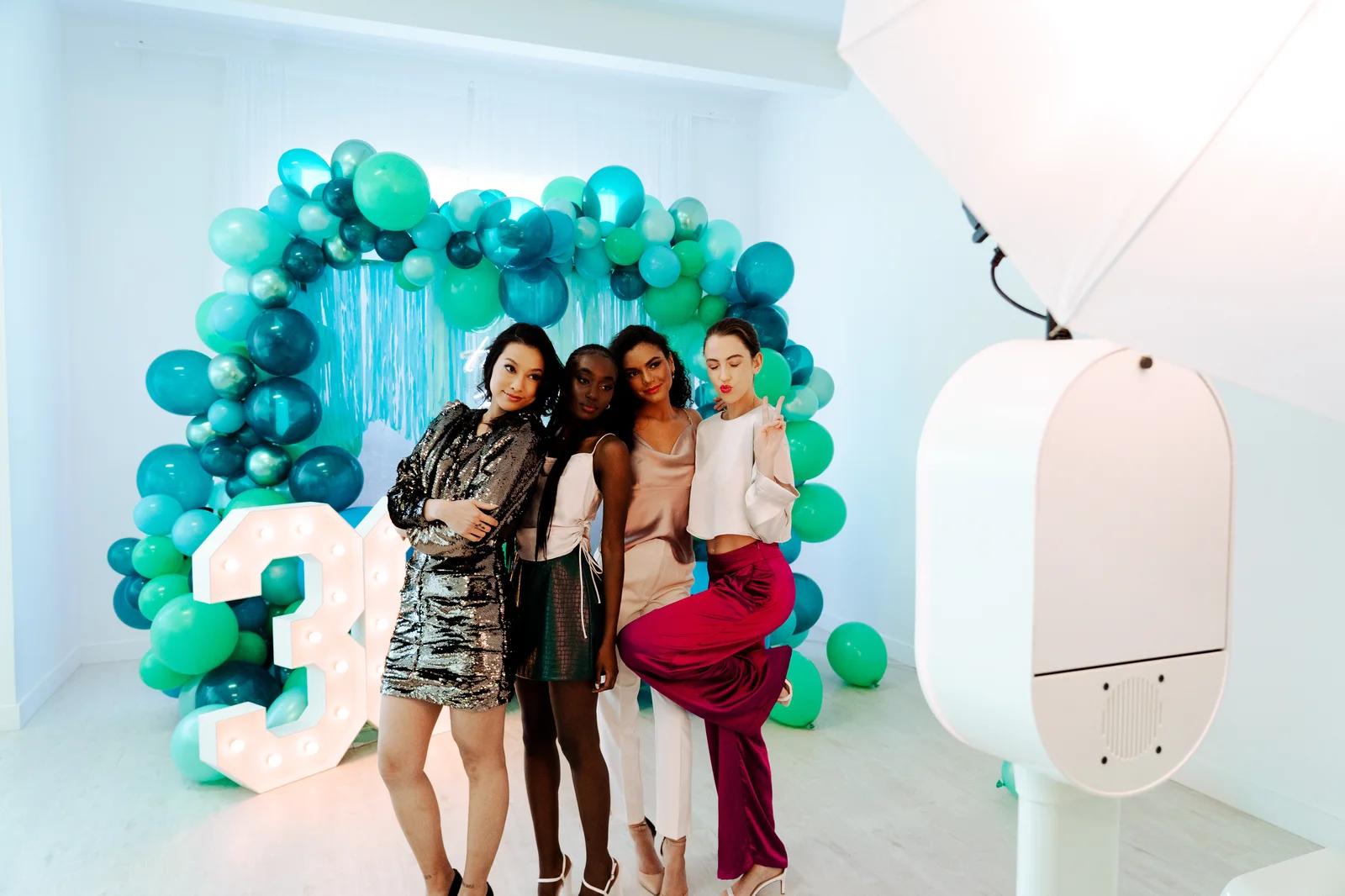 Four women posing at birthday photo booth rental with balloon backdrop — Virginia Beach
