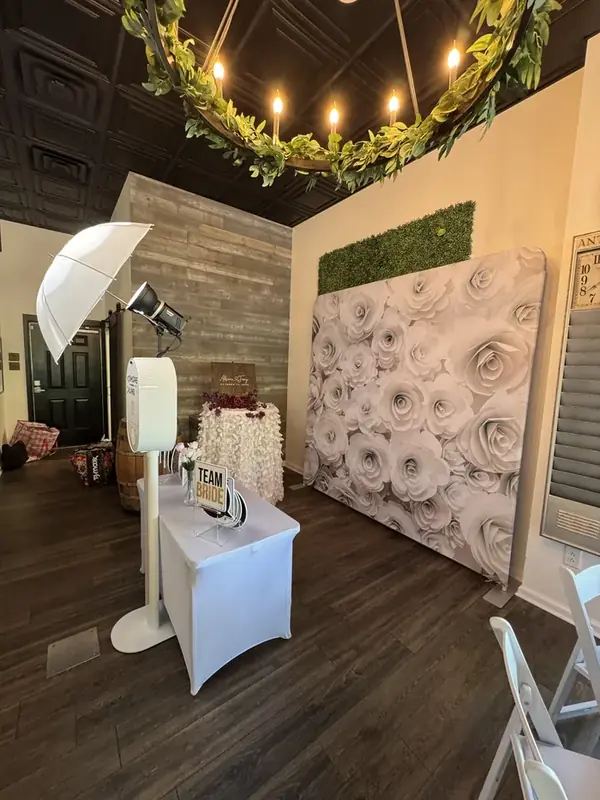 Wedding couple at rose backdrop photo booth Virginia Beach
