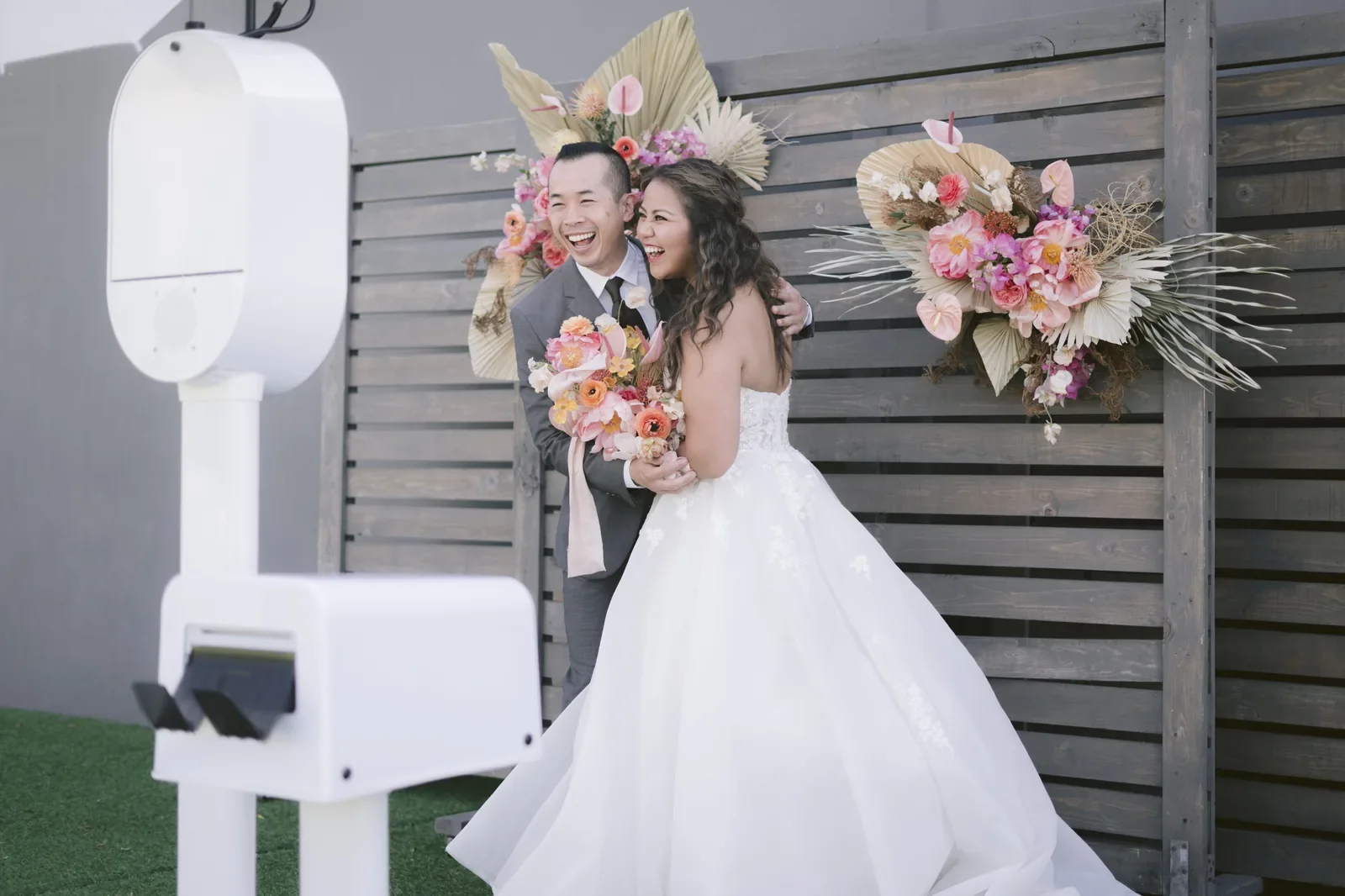 Outdoor wedding couple at floral backdrop photo booth Virginia Beach